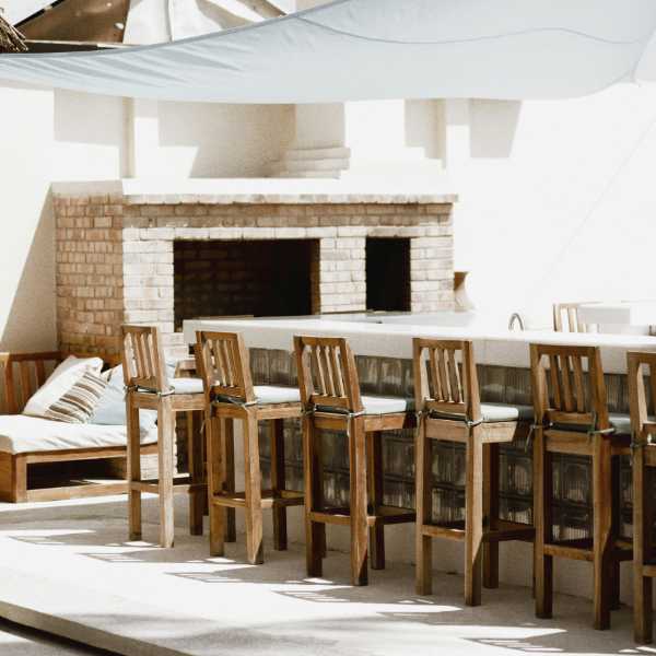 Outdoor fireplace with bar and stools