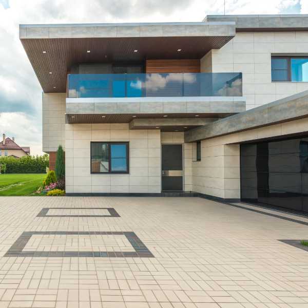 Large modern house with paver driveway